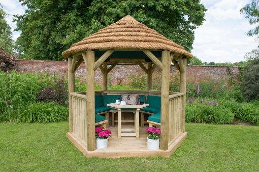 Picture of 3m Hexagonal Wooden Garden Gazebo with Thatched Roof - Furnished with Table, Benches and Cushions (Green)